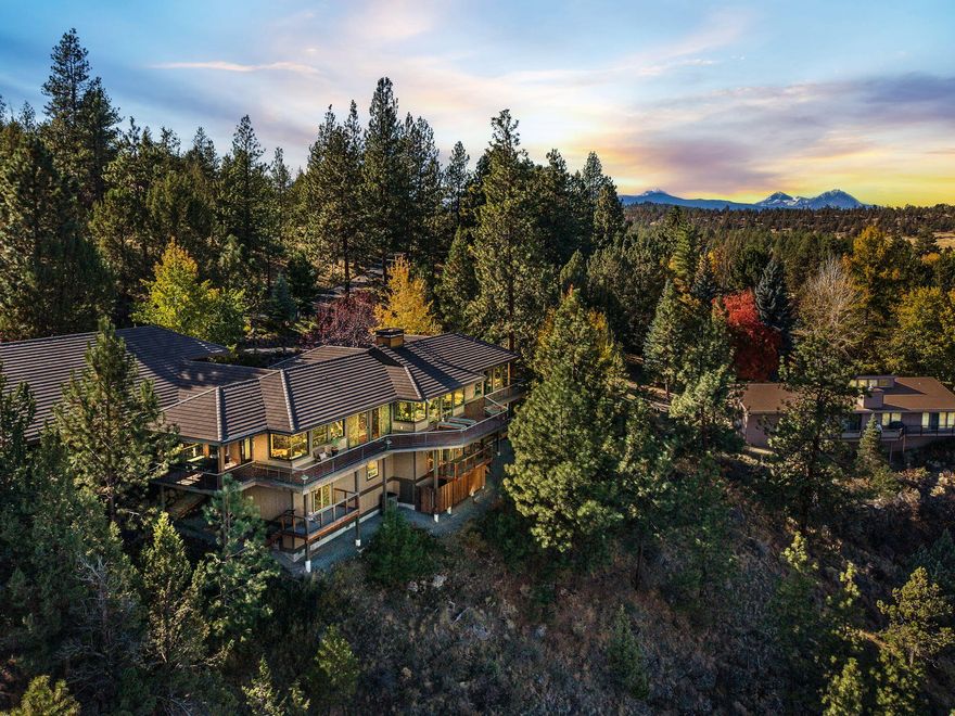 Stunning 5200 sqft home on 1.02 acres in the heart of NW offers Deschutes Riverfront property as well as Cascade Mtn views. The home has new hickory harwood floors, updated interior paint, new light sconces/fixtures/fans, a new heat pump and new humidifying system, 3 en suite bdrms with the primary on the main level w/ a jetted tub, and a great room with a gas fireplace. Downstairs, there is a large bonus room, additional bdrms, and insulted storage space. There is a sound speaker system throughout each room on the main floor. The kitchen has a new dishwasher, new microwave, new oven, and a luxurious 72 sqft island. Fully heated 1330sqft RV garage (floor heat) with black water drain built in, guest quarters with full kitchen, bathroom and loft space. Bonus room off garage and forever views looking and sound of river below. Outside, you will find 4 refinished private decks, a sauna, a water feature, new outdoor fireplace, and beaut landscaping with 6 fruit trees and a heated driveway.