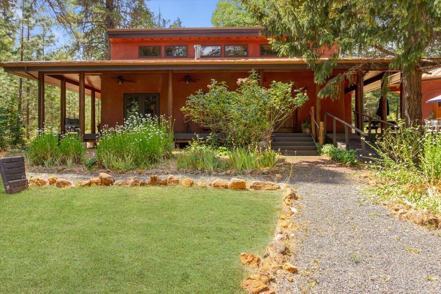 SANCTUARY. There is a feeling of peace and rightness here. This unique property, from the thoughtfully designed layout to the environmental construction, welcomes you like a haven. Retreat. Multi-family living. Compound.  From the inviting covered porch, step into the commons house -a great room and stellar kitchen plus a bathroom and 2 dining areas. Granite counters with plenty of space for multiple cooks to work, custom cabinetry, soaring ceilings, a Viking stove, well planned storage, windows, passive solar and doors in each direction. Here is where everyone gathers. Then, as bedtime draws near, head to the bedroom house, which boasts 2 en suite bedrooms plus a sewing/craft room and meditation/exercise room with a sauna. One could build multiple bedroom houses around the commons house. Nearby is a self-contained yurt with a kitchen and bathroom as well as a studio style bedroom/living area. All on your own private acreage. Gated. Solar.