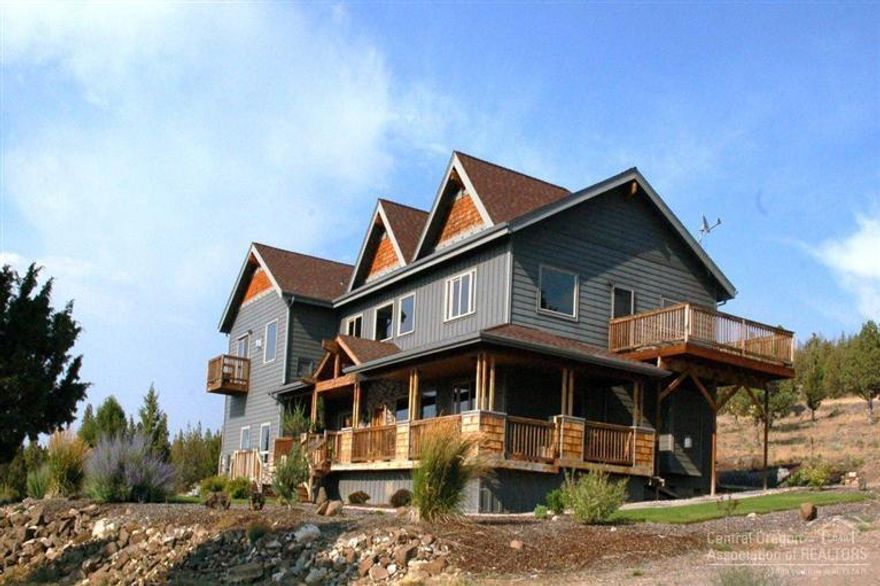 Gorgeous 5 bed 4.5 bath home located on 2 acres in one of Prineville's premier gated developments. Cascade Mtn views, 1300+ sq ft of decking, asphalt paving, landscaped, 3 car garage, cherry wood trim and cabinetry, beautiful tile counters, travertine, tile & carpet floors, jetted tubs & pvt decks off both master bedrooms, all ss appliances, island/cook counter, convection ovens, 2 gas fireplaces, utility room & bonus rec room. Call listing agent for complete list of amenities-too many to list.