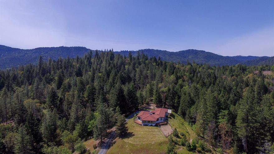 Spectacular views with passive solar architecture characterize this custom, well-built 4 BR, 2 BA home which offers an unbeatable lifestyle for those who value privacy and seclusion.2171 sq. ft. of living space, sited on 16.8 wooded acres the home was designed as two wings connected by a 47x20 open living, dining, kitchen.The 21 x 15 master bdrm. has dual closets and offers cross ventilation for natural cooling.The 7x15 master bath has dual vanities, an oversized jetted tub and separate shower stall.Each of the remaining bedrooms is approximately 12x10 and the 10x6 guest bath features a bath/shower combination divided from the vanity area, and features floor to ceiling built-in custom cabinetry.The kitchen offers large granite countertops and is open to the dining/living area. Hardwood and tile floors, lots of built-ins, three garden spaces, fruit trees, high producing well, complete privacy and bordered by 500 plus acres of BLM land. Too many features to list. Come See It!!