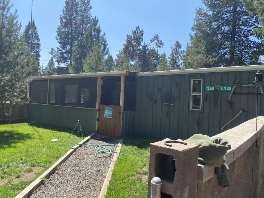 Cute cabin on corner lot. Open kitchen that flows into the living room/bedroom.. Propane stove to keep the cabin cozy in the chilly Central Oregon nights. Lots of out-buildings and one has a laundry room with a shower. Nice wrap around porch. There's also a bunk house for company. Fenced yard with lush green grass. You can access the home in a separate drive-way that's gated from Strawn Rd. Nice dog kennel. Close to the corner store and all the High Lakes. The possibilities are endless!!