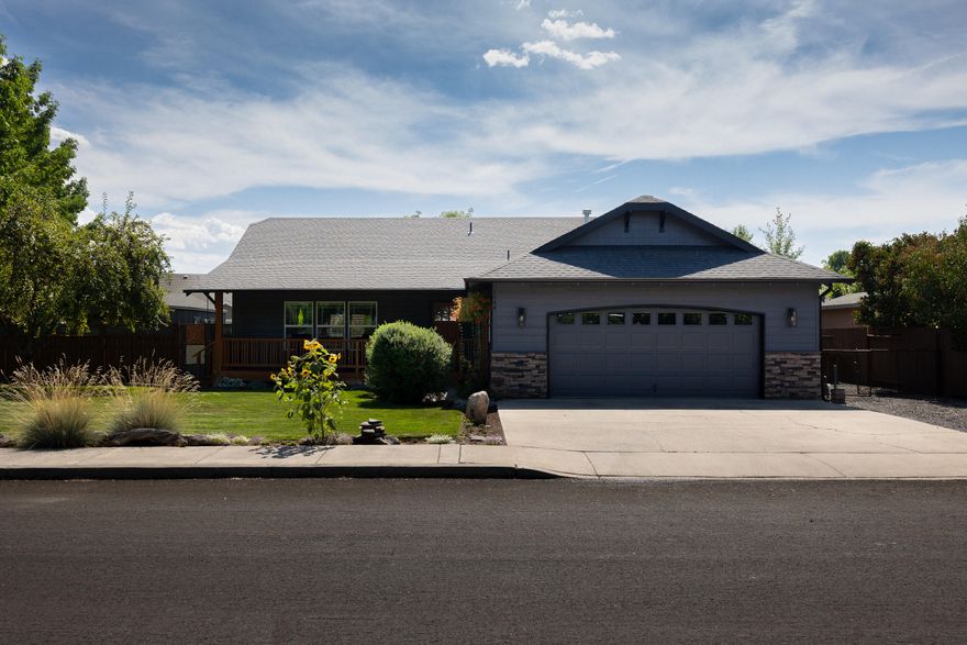 Updated home one block from Dry Canyon. Stylish remodeled gem in Northwest Redmond, just on block from the Dry Canyon. A spacious great room flows into a beautifully updated kitchen with granite counters, new cabinets, farmhouse island sink, additional prep sink, professional appliances, subway tile backsplash, luxury plank vinyl flooring, and modern lighting. Bedrooms feature plush carpeting, and the primary suite offers double vanities and a walk-in closet. Fresh exterior paint, trim, and a newly painted board fence boost curb appeal. The corner lot includes extensive RV parking, a fully fenced backyard with shade tress, cane fruit, and a covered patio. A 10x30 detached utility building provides flexible use as an office, studio, or workshop. Natural gas heating and whole-house A/C. Near schools, shopping, parks, and Dry Canyon trails - move-in ready!
