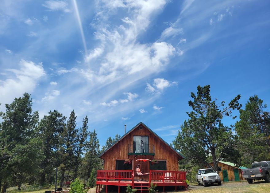 This is the off-grid cabin you've always dreamed about—so much more than a cabin, it's a home built for the entire family. Set on 80 acres and anchored by an old-growth Ponderosa pine, the property carries the same strength and permanence as the trees that define it. Petroglyphs mark the land's history. A pond holds water through the season. Elk, mule deer, bear, and mountain lions move across the ground.

Alongside the cabin, a workshop and yurt extend space for living, work, and guests. Solar power and wood heat keep it self-reliant. Here there are no neighbors, no lights—connection only when you choose. At night, under the Milky Way, the land is a Dark Skies sanctuary, a place where even a hurried mind can settle into priceless calm.