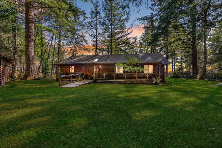 Charming log-style home on a gated, forested lot, complete with garage and shop! Cozy up by the wood stove, or take a
dip in the indoor hot tub as you enjoy a partial ocean view. This home features high ceilings, a large bonus room with french
doors, privacy, and plenty of space to spread out both inside and out. Enjoy the covered porch and the sounds of nature, only a
short drive to the beach.
