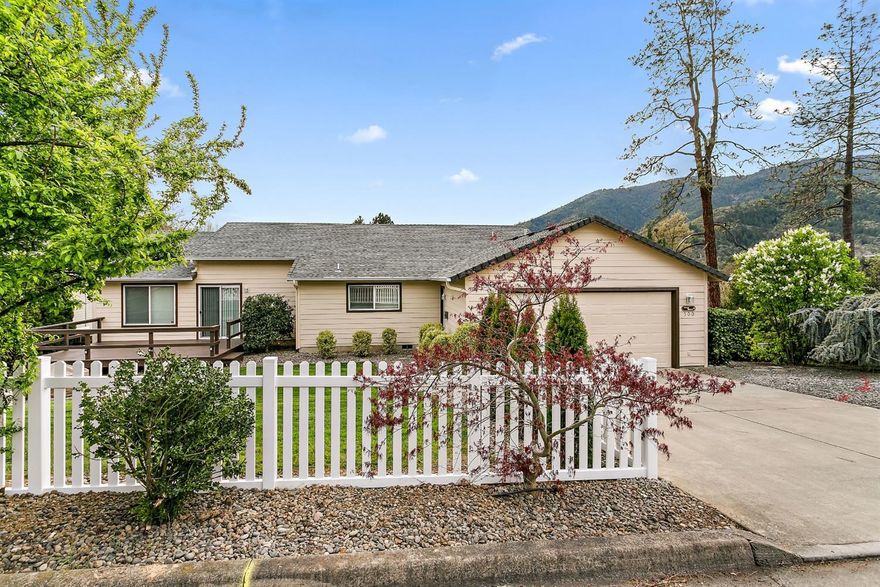 Beautiful Single Level Home located in Cedar Ridge Subdivision on .24 acre in Rogue River! Enjoy your morning cup of Joe from the covered front deck overlooking gorgeous valley and mountain views. This lovely home features 3 bedrooms, plus an office/den with French doors (could be a 4th bedroom), 2 baths, new carpet, vaulted living room & family room, ceiling fans, large open kitchen with stainless steel appliances (except dishwasher is black), walk-in pantry, eat-in breakfast bar, and plenty of room for a large dining room table. The Master Suite features a walk-in closet, and walk-in shower and jetted tub in the master bath. Wired for internet & cable throughout, large laundry room, plus a huge 1334 S/F walk-out unfinished basement, great for storage. Exterior features include newly painted Hardi-Plank siding, new white picket fence in back yard (garage side), plus a gas fire pit and deck for entertaining. Close to shopping, schools, and the wild & scenic Rogue River.