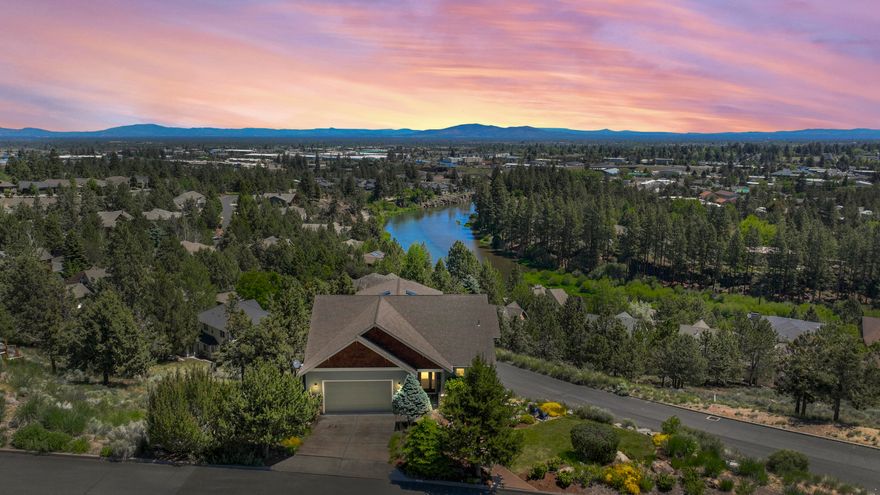 Take in panoramic Deschutes River views from nearly every corner of this versatile Bend home. With dedicated guest quarters, main-level primary suite, and 3 viewing decks, there's space for everyone. Rare option for single-level living on the main w/ kitchen, living room, laundry, and primary suite (complete w/ Pilot Butte views) all on one floor. Downstairs, you'll find 3 bedrooms, each w/ access to the private deck and a sauna. Upstairs, the guest suite features kitchenette, two bedrooms, and large open living area w/ sweeping views ideal for a home office, studio, multigenerational living, or party pad. Outside, a flowing water feature welcomes you, and grassy areas offer room to relax, play, or enjoy the view. Recent updates: new HVAC/ tankless HW (2019)/ quartz counters in the kitchen and baths. Located just a short bike ride from everything Bend has to offer and w/ river access for your paddle board just down the hill this home is your front row seat to to the Bend lifestyle.
