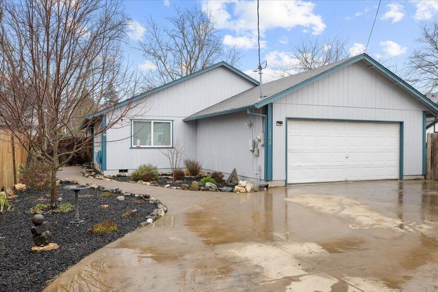 Discover the perfect blend of charm and functionality in this inviting home! It features vaulted ceilings, expansive windows, and newer LVP flooring. The kitchen offers a convenient breakfast bar and ample cabinetry, ideal for everyday living and entertaining. Nestled just outside of town, enjoy peaceful living away from the hustle and bustle while staying close to shopping and a short drive to historic Jacksonville's dining and culture. The private, fully fenced backyard is a serene escape with mature trees, garden beds, and plenty of space to relax or host gatherings. The spacious primary suite includes an ensuite with a shower-tub combo. Additional perks include storage sheds, expansive parking for RVs and extra vehicles, and a gated driveway for added security. This home offers comfort, privacy, and convenience—all in one!