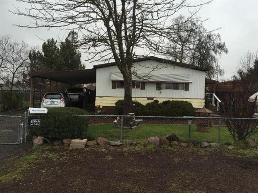 Seller has reduced the price and is highly motivated to sell. Finally a mobile home on land that can be financed, either FHA, VA or conventional. Close to major shopping and restaurants but a feeling that you are out of the big city. Mature landscaping, locking gate, curbs and sidewalks. Relax in the backyard under one of the fruit trees, or on the covered deck. Large storage shed. Interior of home is very well kept and some of the furniture will be sold. Large walk in closet in the master bedroom, indoor laundry room with lots of cabinets. Roof in very good condition, installed 11 years ago per seller.