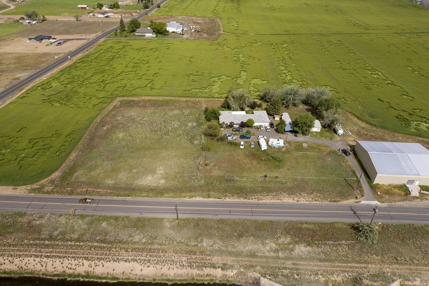 Great one level Ranch style home with Living Room, Family room and 2 additional flex spaces. Large Utility Room. Site built Home is 3 Bdrm 2 ½ bath 2090sf built in 1979 and the Mfg. Home is 3 Bdrm 2 Bath built in 1998 1080 sf. Both dwellings are permitted and legal per Jefferson County Planning Dept . Two separate permitted and approved septic systems on the property. Homes have deferred maintenance and property is priced accordingly. North Unit Irrigation water rights. Double attached garage on the main house. Two Other storage buildings on site. Wonderful Cascade Mountain views from the subject property and Views of the Buttes to the East. Surrounded by larger farm parcels. Gas furnace with heat pump. Mature landscaping. Asphalt driveway and parking. Lots of room for RV parking.
