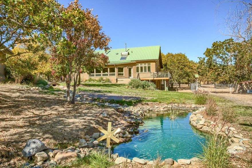 Two-family set-up built in 2002 on 4.08 acres in highly sought-after Jacksonville within a short distance to Applegate River. Main dwelling is 3511 sq ft, 3 bed, 2.5 bath, 3 levels w master bedroom & full bath, kitchen, dining, living, laundry, mudroom on the main; downstairs 2 bed, 1 full bath, storage; upstairs has an office w plenty of storage, half bath & study area. Post & Beam, earthen plasters, straw-bale insulation, Kachelofen masonry woodstove, solar hot water, on-demand water heater & other green features. Includes a wraparound deck, gas stove, radiant floors, skylights, custom tilework & plenty of storage. Detached Adobe studio is 2066 sq ft w high ceilings, 2 large open areas, 2 closed areas, 2 lofts, 1 full bath, attached 1 car garage & covered outdoor sitting areas. Well maintained mostly flat, useable zoned RR5 land, garden area, chicken coop, ponds, well, two-5000 gallon rain tanks, paved basketball court, detached office, covered firewood & expansive views!