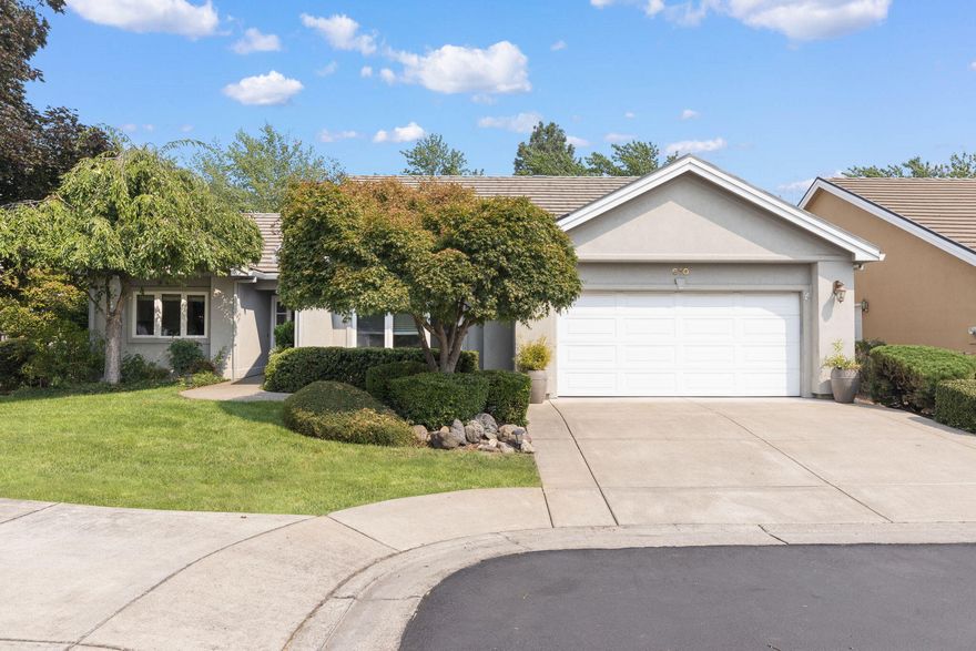 Pride of ownership shows inside and out on this lovely 2 Bdr, 2 Bath home located in the finest Gated community of Alder Creek!  Located at the end of a quiet cul-de-sac with views of mature trees and lovingly tended  roses & hydrangeas to enjoy off your Covered Patio!  As you enter the home, the foyer opens to the expansive Living Room and Dining Room with Vaulted Ceilings giving a very spacious feel.  The gas fireplace and mantel complete the coziness of this home.   Large kitchen with New Stainless Refrigerator and Sink, lots of counter space and cabinets. New wood-look vinyl plank flooring throughout.  Large windows create an abundance of natural light.  Spacious Primary Bedroom with nicely updated  Bathroom en suite,  including, skylight, new vanities with granite countertops, easy-step shower & upgraded lighting!  Fresh Interior Paint!  The HOA covers all landscaping creating a pristine neighborhood and easy-living yard.  Conveniently located near shopping, medical and golf!