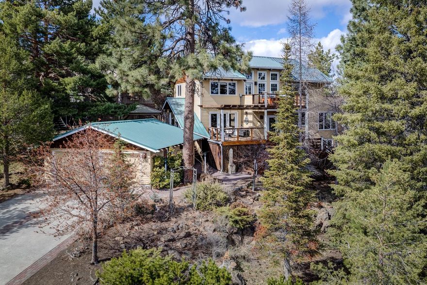 NW Craftsman home with partial views of 1st Street Rapids and SW Buttes. Beautiful finishes include open beam ceilings, wood floors, built-ins and a wood burning fireplace.  Kitchen with tile counters, eating bar, stainless steel appliances to include double ovens.  Den/office or sunroom with French doors and slate floors. Upstairs primary bedroom suite with a balcony and an updated primary bath with tile floors, radiant heat, tiled walk-in shower and a soaking tub.  Updated guest baths and upstairs deck with hot tub. Closets with built-ins.   200+ SF Bonus room or office with a separate entrance.  Newer furnace and AC unit.  Front deck and pergola create ample outdoor seating.  Detached double car garage.  Check with the City of Bend for short term rental eligibility and possibility of an ADU.  No CCRs or HOA.