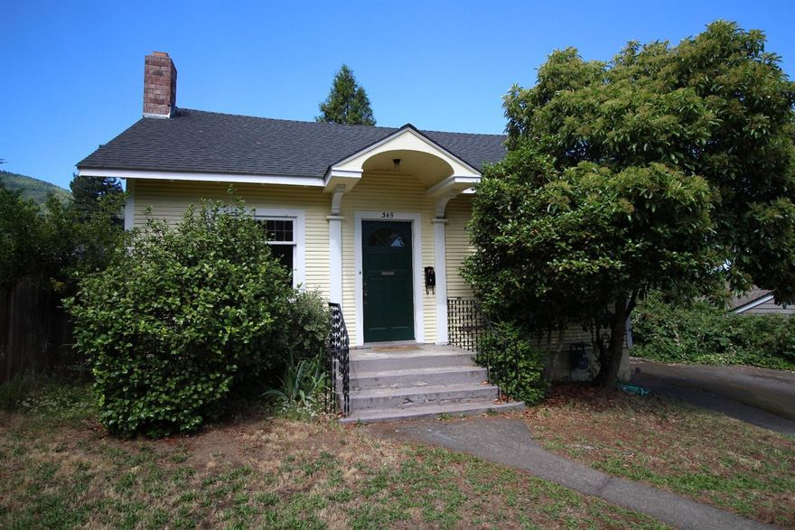 Built in 1932, this light and bright three bedroom, two bath home has charm and hidden features. Set back from the street and on a generous .20 acre lot, this classic Ashland charmer features high ceilings and hardwood floors throughout. The coved ceiling in the living room lends a period-appropriate charm to the room. Wood windows, tile showers and kitchen counter are gracious touches. Don't miss the hidden staircase which leads up to a partially finished attic that could be finished out and turned into another 500+ sq' of living space. Partial basement beneath the house. The generous back yard features a large deck, fruit trees, and ample room to garden. Step from the garden through the mud room into the kitchen. Separate laundry room. Detached single car garage in the back provides a variety of options. All appliances are included. Easy walking distance to the Ashland Plaza on this stately, tree lined street.