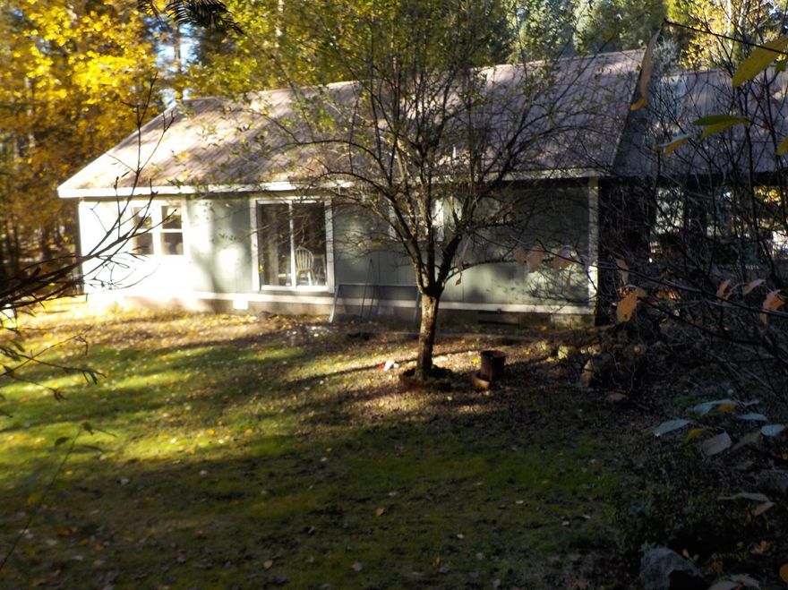 This is a really cute rural property. The home is modest, but has been well maintained. There are now only two bedrooms as the smaller bedroom in back was divided and now there's a walk-in closet in the master bedroom and an office near the back door. There is a really large carport with an additional metal carport in back for owner's boat. The owner recently removed the carpets in the bedrooms and discovered there are nice wood floors in both bedrooms. Inside utility and a great wood stove for heating the home. Also two ceiling fans to move the heat around. There is backup heating with electric baseboards. Excellent well (per owner), septic has been pumped in last three years, lots of big trees (timber) on property plus one really good apple tree. Rural area but close to town. Wood stove stays but owner is keeping the wood in the shed. Be Aware of Large Dog!!!