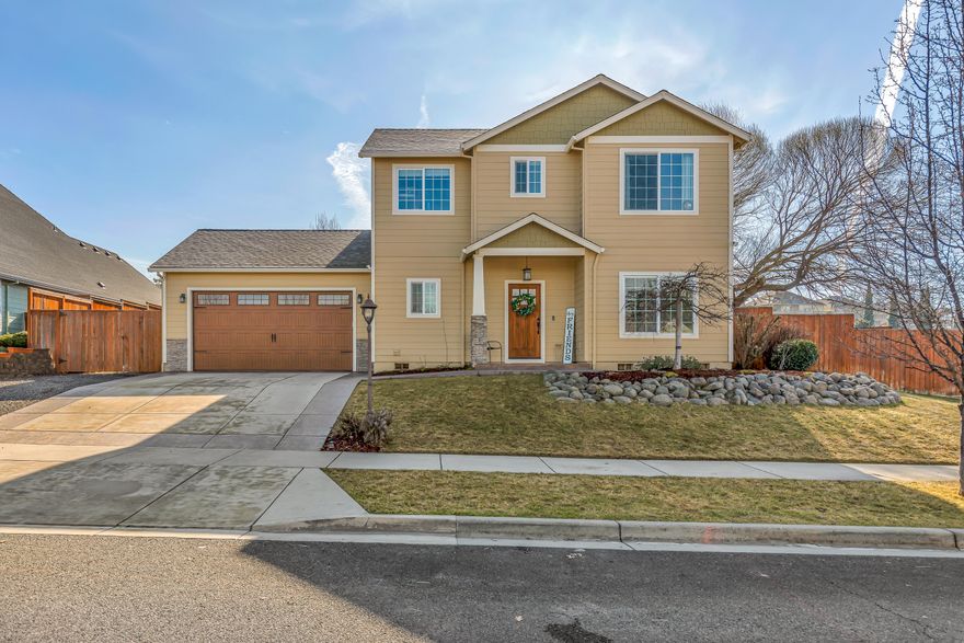 Warm and inviting home in a coveted E Medford neighborhood! This home has been loved by the same family since it was custom-built in 2014 and features a thoughtful layout, surprisingly large yard, and end-of-the-road privacy. The entryway opens to spacious 10' ceilings, a half bath, and an office or potential fourth bedroom. A wall of southeast-facing windows overlooks the open-concept living room, dining room, and kitchen that flow together seamlessly. With ample counter space, bar seating, and a large pantry/laundry room, there is plenty of room to spread out, while the floor-to-ceiling rock feature and gas fireplace lend a cozy feel to the space. The upstairs is highlighted by the generous primary bedroom with a romantic bay window, two walk-in-closets, his & hers vanities, and a luxurious jetted soaking tub. The backyard offers room to run, plus an established garden area and a fire pit, topped off with room for extra storage/small boat parking and eight fully-owned solar panels.