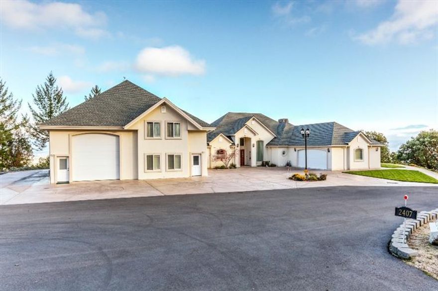 Absolutely amazing home in an area of prestigious private estates with breathtaking, top of the valley views! Enter the home to soaring ceilings, marble-like columns and both formal living and dining rooms. The magnificent kitchen, which is a chef's dream, offers granite counters, oak floors, cherry cabinets, elegant rope lighting and stainless appliances. The kitchen opens to the family room and breakfast nook, both with spectacular views. Master suite offers two walk in closets, dual vanities, soaking tub, tile shower and enclosed Lanai to enjoy the winter views in comfort. This home is truly amazing along with a separate 2500 square foot shop, for parking your toys. All of this is located on 20.49 acres with access through a private gated, paved street. You will feel like you are secluded, but are very close-in to Jacksonville and Medford. This home is truly worth touring today!!!