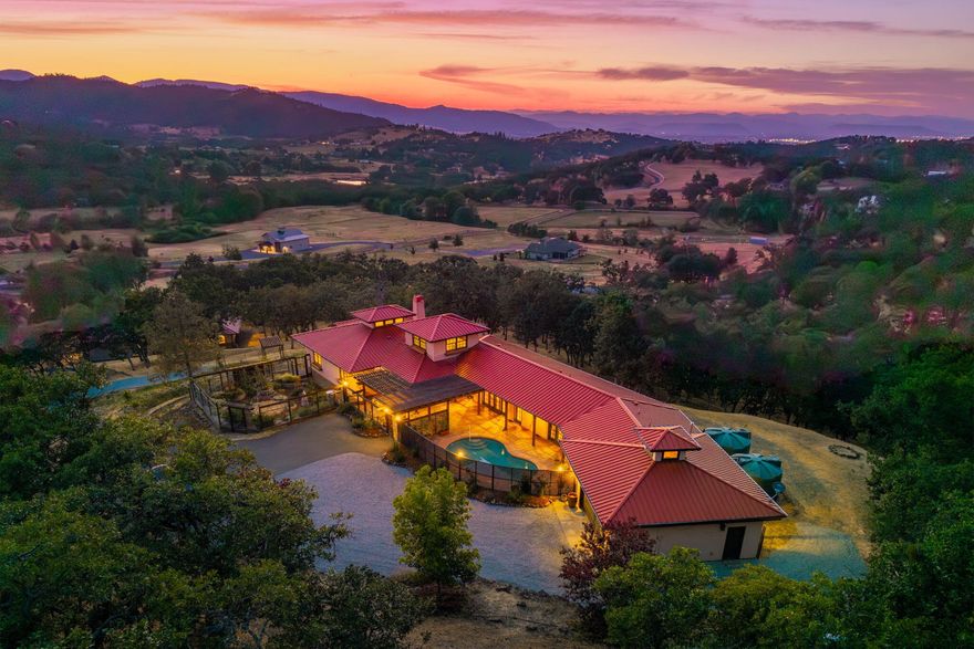 Custom Strawbale-insulated serene spa-like living w/stunning views. Paved drive w/elec gate opens to 6.62 fncd acres w/organic garden. Stucco ext w/fenced courtyard, flagstone walkways, heated saltwater pool, palm trees, window boxes & nite lighting. Wood-clad alum windows. Cupolas w/elec windows. Finished 2 car garage plumbed for bathroom. Stunning interior bamboo and cork floors, great room w/10' beamed ceiling & soapstone wdstv. 8' French doors lead from dining room to sunroom which opens to patio. Open kitchen has 5 burner cooktop, dbl conv ovens, coffee bar, granite counters & cherry cabinets. Mstr suite opens to courtyard, dbl sinks, claw foot tub, glass shower & tiled floors. Guest ste & 3rd bedroom/den leading to courtyard. Upstairs 230 sf office w/360˚ views. 1200 sf insul out-bldg wired for 220, HVAC, full bath, mini kitchen, professional recording studio or home theater, 300 sf deck w/valley views & 1000 sf carport. Irrigated w/10,000-gallon rainwater catchment.