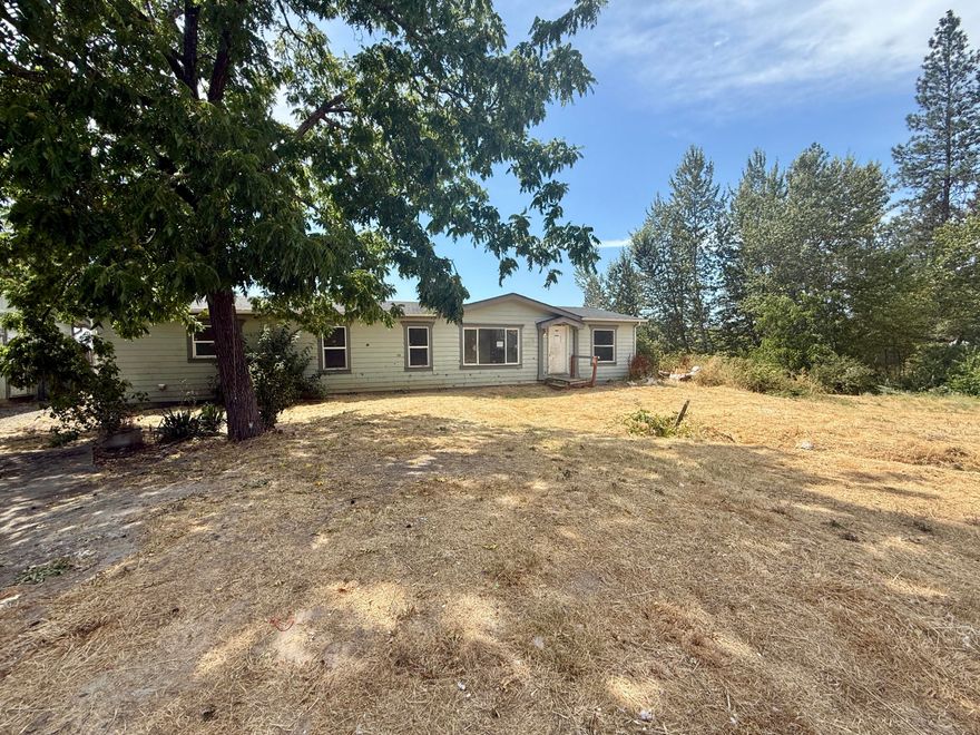 Wow what an opportunity to be had!!    Bring back to life this property which is on well and septic and zoned Rural Commercial.   Large and flat property is the key for plenty of space for your activities.   Great Visibility on Redwood Avenue.  3 bed/ 2 bath Manufactured home with detached garage for all your hobbies.