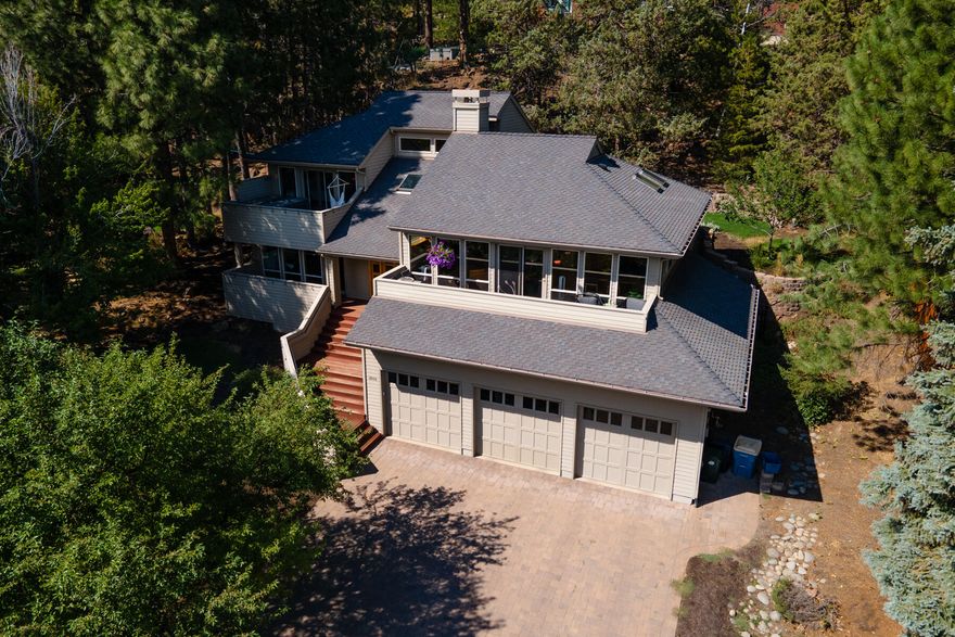 Take in the city views from this beautiful West Hills home in Bend, Oregon. This three bedroom + bonus room, 3 bathroom home has high end custom finishes throughout. The gourmet kitchen has a subzero fridge, wolf oven/range, and granite counters. Multiple decks on both the front and back of the home allow you to take in the views and enjoy the mature landscaping. The 3 car garage offers 1,197 sqft of heated space.