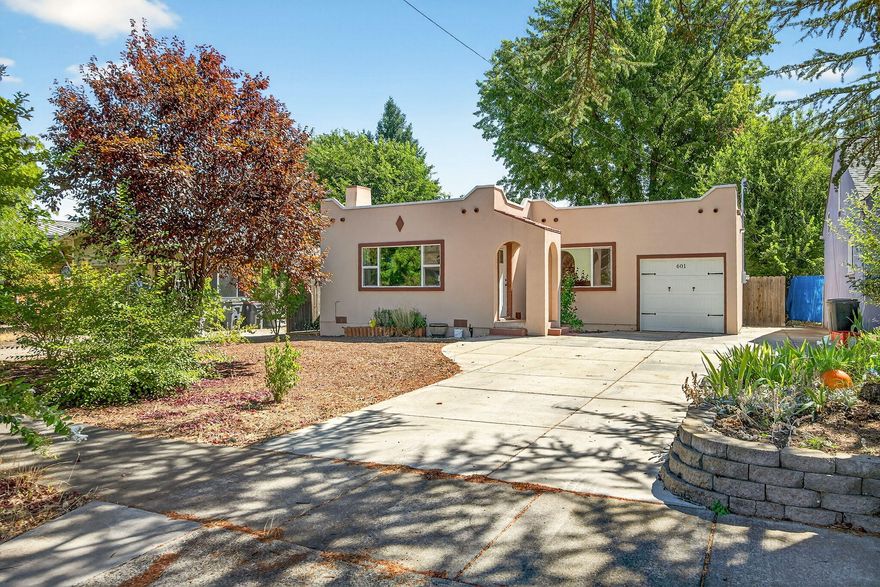 Charming Home Near Downtown Medford! Discover this beautifully updated 2-bed, 1-bath, 953 sqft gem, built in 1927 and renovations completed by 2020. Sitting on a .17-acre lot, this home blends timeless charm with modern upgrades. Original hardwood floors, high coffered ceilings, built-in cabinetry, and a quaint fireplace mantel with a new electric insert create a cozy ambiance. Enjoy a fully remodeled kitchen and bath, new roof, updated electrical, energy-efficient lighting, new windows, stucco exterior, and a high-efficiency furnace with AC. Enhanced insulation ensures year-round comfort. The spacious, fully fenced backyard features a large patio, perfect for relaxing. A new driveway, RV parking and attached garage offer ample parking and storage. Located in a well-kept neighborhood, just minutes from vibrant downtown Medford, shops, dining and festivals. This home offers the perfect mix of historic elegance and modern convenience. Don't miss this rare find!