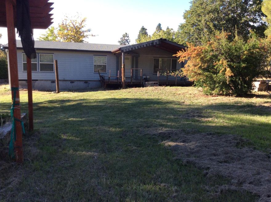 Here is a wonderful place to settle down in Southern Oregon.  Home sits on a little over an acre of land. Two car oversized heated garage sits on the back of the property.   Three bedroom, 2 bath, formal dining room and family.   Kitchen has a new stainless steel stove, microwave and dishwasher.  Other appliances included are the washer and dryer and the refrigerator.  Master bedroom has a wonderful soaking tub and a shower plus a large linen closet.   Home is needing new carpet and paint.