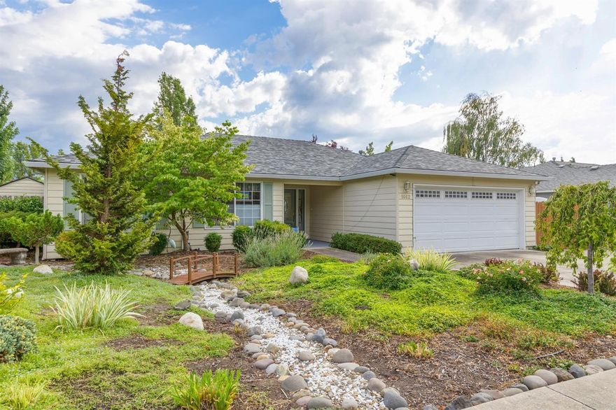 Delightfully designed and beautifully appointed home and gardens! From the unique, yet easy care garden landscapes in both the front and back, to the superbly maintained and exquisitely appointed finishes within the home you will not be disappointed. This home offers a bright open floor plan with coffered ceilings, crown and base moldings, a corner gas fireplace with a wood mantle and marble surround. You'll also find hardwood floors throughout the kitchen, living room, dining room, laundry room and hallway and tile floors in the entry and bathrooms. The three almost floor to ceiling windows in the living room overlook the private back yard garden and covered patio. Home also offers paved RV parking, lots of storage including a spacious walk-in closet in the master bedroom. The home has been freshly painted with light earth tone colors. New roof in 2015.