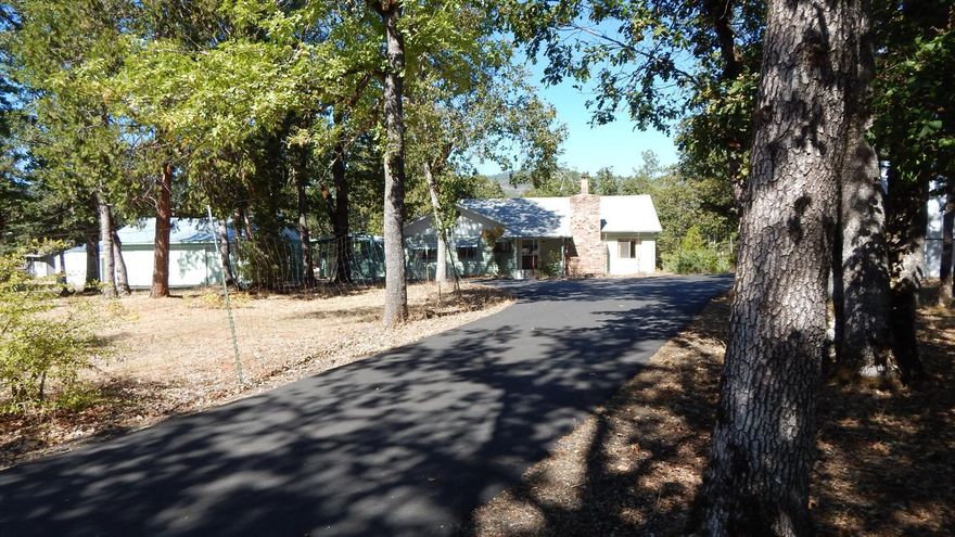 Charming home with lots of local history. This 2-bedroom, 2-bathroom home of 1,420 sq. ft. has room for expansion and is located in what used to be a walnut orchard. In addition to the home are three large outbuildings, one a two car detached garage, one a three bay shop/garage and the third is a large metal RV cover. In the middle of the circular drive is the old garden plot already fenced.