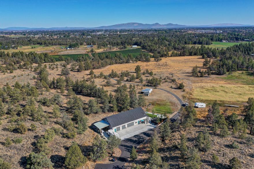 Incredible 110 Acre Certified Organic Farm in the Heart of Redmond with 68 acres of COI irrigation & Cascade Mountain Views! Private paved driveway leads to this great 2015 Built, 2200sf home featuring: vaulted Great Room w/radiant floor heat + mini-split for AC, certified wood stove, open dining/kitchen w/slab quartz counters, back patio w/fire pit & hot tub, attached 2000sf garage/shop heated & cooled! Additional 900sf Farm House/Guest Quarters located off Hemholtz features; 2Bd/1Ba, completely renovated in 2015, large hay barn, block milk-barn building, green house & yurt included! This incredible location leaves lots of options only 3 miles from town!
