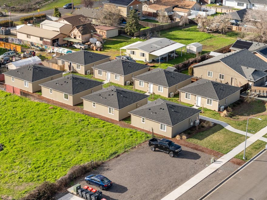 Premier Multi-Family Investment Opportunity! Welcome to this unique Cottage cluster. A recently built 8-detached unit facility offers a rare opportunity to own a turnkey, low-maintenance investment property in the heart of Medford, Oregon. Constructed in 2023, these modern, single-level residences are designed for maximum tenant appeal and long-term rental stability. Each of the eight 2-bedroom, 2-bathroom homes (16 bed, 16 bath total). are thoughtfully designed with no common walls, providing a private and peaceful living experience. The high-quality finishes include granite countertops, laminate flooring, and in-unit laundry, ensuring strong tenant demand. The property is leased at $1,650 per unit, generating an impressive rental income around $158,400 annually.