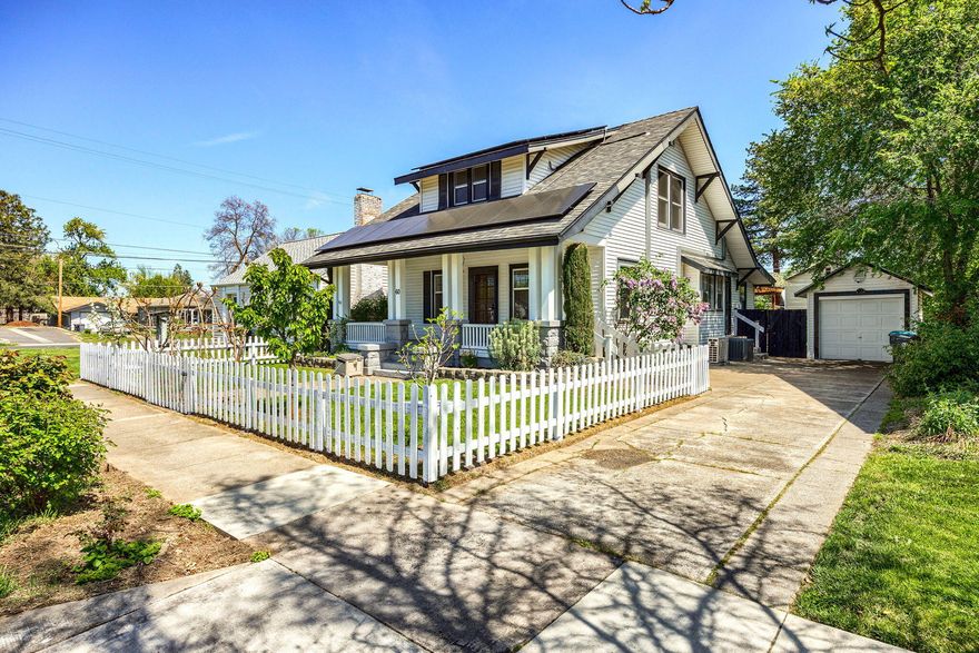 This absolutely charming 1912-built cottage seamlessly blends historic character with modern updates! The home boasts 9 newer double-pane windows, solar system, and a furnished guest house with great income potential. The main house features a stylish cook's kitchen, updated stainless steel appliances, and modern updated bathrooms. Wood and tile flooring enhance the home's charm and appeal. Newer ductless heat pumps and an updated heat pump system provide year-round comfort. The spacious living room, anchored by a charming fireplace, flows effortlessly into the dining area, showcasing built-ins. Outside, enjoy a delightful deck surrounding the hot tub, raised garden beds in the expansive backyard, and a spacious shop and shed for additional storage. The guest house, with a full bath, offers privacy with its own fenced yard and separate parking. This property is a perfect blend of comfort, charm, and AirBNB rental potential.