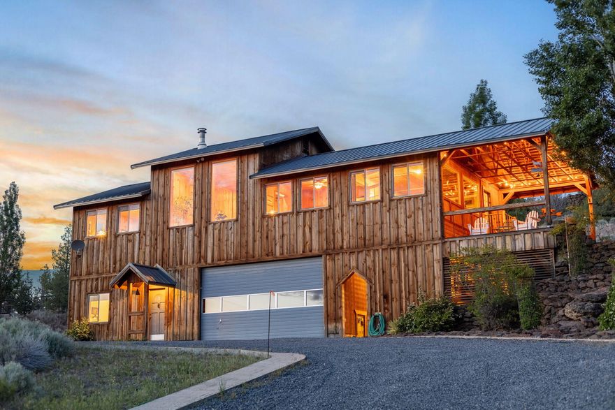 Private Hilltop Retreat with Cascade Views - Custom Home + Cabin on 5+ Acres
With sweeping views of the Cascade Mountains and overlooking the Deschutes River Gorge, this custom home offers the perfect blend of rustic charm, modern comfort, and a unique homestead opportunity. The home features wood siding, wide plank wood floors, and beautiful blue and buggy pine interior finishes. The spacious great room showcases a dramatic wall of windows that frame the stunning mountain vistas, complemented by a cozy wood stove. A separate family/sunroom provides additional space for relaxing or entertaining guests. The country-style kitchen is equipped with stainless steel Viking appliances. Enjoy year-round beauty from the covered deck. Additional features include a 2-car garage with a 10' door, a separate shop area, and a chicken coop. A detached cabin on the property offers even more flexibility. This retreat is close to public lands and river access, offering endless outdoor opportunities.