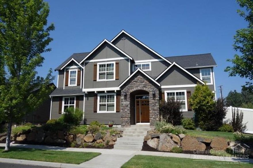 Beautiful home in a GREAT neighborhood in SE Bend! 4 bed, 2.5 bath 2614 sf w/Den/Office/Bonus Room - could be 5th bedroom. Large open Great Room w/ big rock fireplace! Formal dining room with wet bar area, hardwood floors, Granite counter tops, central vac & AC. Oversized lot with privacy fence & stamped concrete patio, great for entertaining! Large master bedroom w/a huge Travertine tile shower & deep soaker tub to retreat to after a long day. Upstairs Laundry w/all the bedrooms... three car garage...more!