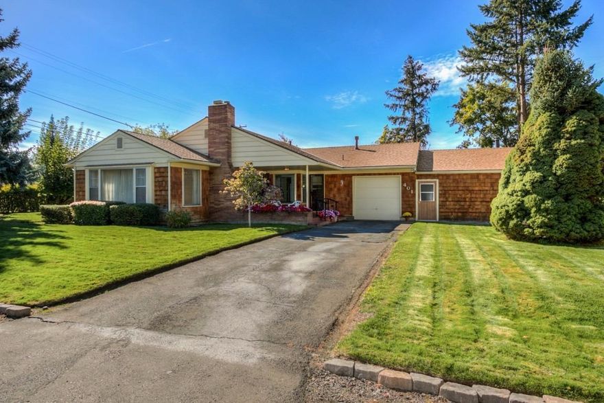 Adorable 50's home on a beautifully landscaped, Old East Medford lot! An inviting covered front porch, gorgeous hardwood floors, a beautifully tiled fireplace with mantle and a large living room with lot's of windows and light. Formal dining room with a period chandelier, large kitchen with painted cabinets and tile countertops, butlers pantry/utility room combo, with separate entrance. Two large bedrooms with hardwood floors and an adorable tiled bath with original, well cared for fixtures. Single car garage, large storage area or 2nd car garage and an additional office or workshop area. Lot's of possibilities for this mid-century home on a large corner lot!