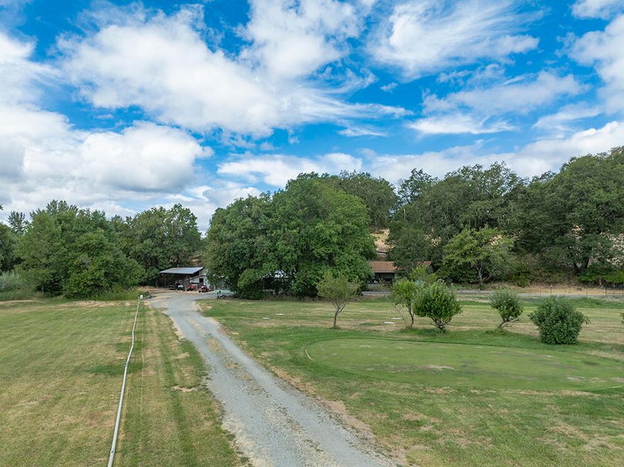 Farm sweet farm on 6.16 irrigated acres with peaceful Dutcher Creek meandering the property. Quaint 1162 sq. ft., 2 bed, 1 ½ bath home on this amazing property that has so much to offer: Fruit trees galore: plum, pear, apple, cherry, and fig, 4 very large commercial greenhouses, huge fenced in garden area, RV parking with power and water, a 12' X 16' storage room, a large shop with attached carport and bonus room, and a big barn. All of this borders the beautiful Dutcher Creek Golf course.