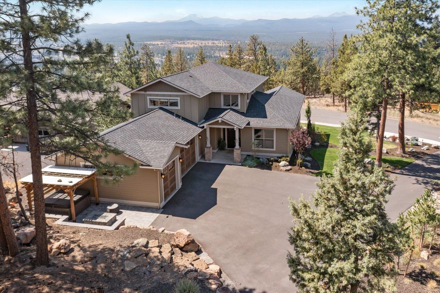 Perched near the top of Awbrey Butte, this beautifully maintained home on an elevated private lot boasts Cascade Mountain views, a flexible floor plan, oversized three car garage, two exterior living areas with fireplaces, approved ADU plans, and coveted space to spread out.  The open kitchen boasts loads of natural light, quartz countertops, soft-close cabinetry, eating island and high-end stainless appliances.  The main level primary bedroom is airy and bright with a spa-like master bath with soaking tub, tiled shower and spacious walk-in closet.  Enjoy wood floors on the main level and hand troweled walls throughout.  You'll love the spacious mud/laundry room off garage. Both the office and bonus rooms have closets so can easily flex to a 4th bedroom.  A 612 sf one-bedroom ADU has been previously permitted and approved on the lot and plans are available with accepted offer. An invisible fence surrounds the well manicured yard. This home checks all the boxes!