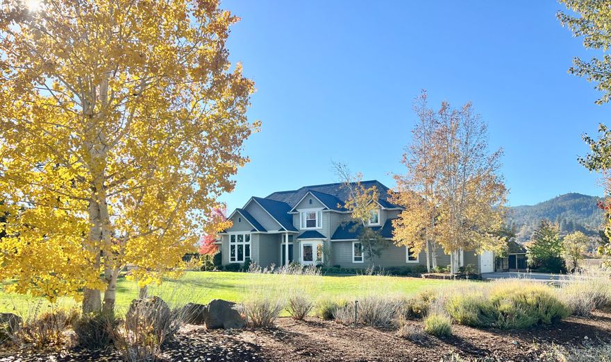 Set amidst 21.5 private acres, this extraordinary equestrian estate offers an authentic ranch experience mere minutes from town. The grand foyer introduces a great room with 25-foot ceilings and floor-to-ceiling windows, showcasing breathtaking views of snow-capped Mt. McLoughlin. A gourmet kitchen is appointed with granite countertops, high-end appliances, three sinks, coffee bar, and butler's pantry with ample storage. The primary bedroom features a lavish en-suite bath, including dual vanities, walk-in shower, soaking tub, and walk-in closet. Three spacious bedrooms upstairs — two with en-suite baths — enjoy lovely views of the Rogue Valley. The heated barn includes tack room, laundry room, three stalls with covered runs, & grooming bay. Additional amenities include two outdoor arenas, pivot irrigation system, paddocks with loafing shed, covered hay/trailer parking, two-car garage/shop with guesthouse and a spacious patio complete with koi pond.  Too  much to list here!