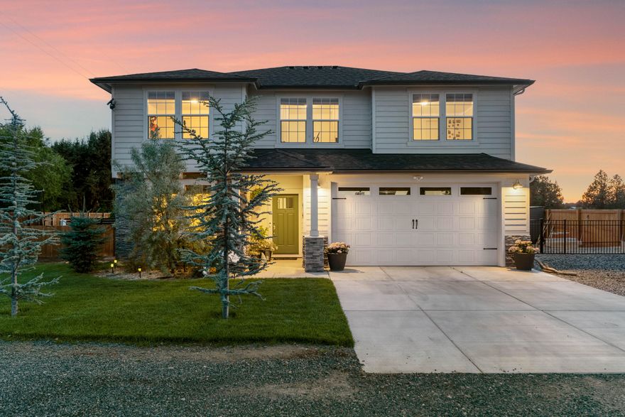 Welcome home to this stunning custom-built 2,578 SF home on nearly ½ acre of serene farmland, just on the edge of town. Better than new, this turnkey home features a fully fenced, beautifully landscaped yard w/ paver patios, gardens, & multiple areas perfect for relaxing & entertaining, plus a hot tub for ultimate relaxation. Inside, enjoy 4 bedrooms, a private office/den, 2.5 baths, & a spacious, open floorplan w/ vaulted ceilings & high-end finishes & a dream chef's kitchen. The main-level primary suite offers a spa-like bathroom & walk-in closet. Upstairs, 3 additional bedrooms, a full bath, & an oversized media room w/ built-in desk. As a bonus, the property includes the fenced, graveled land to the West, making it an ideal location for a shop, ADU, or future development, not to mention a spacious 588 SF attached garage w/ RV parking. Located across the street from the 159-acre Pine Nursery Park w/ easy access to shops, dining, & the Parkway, country living meets city conveniences