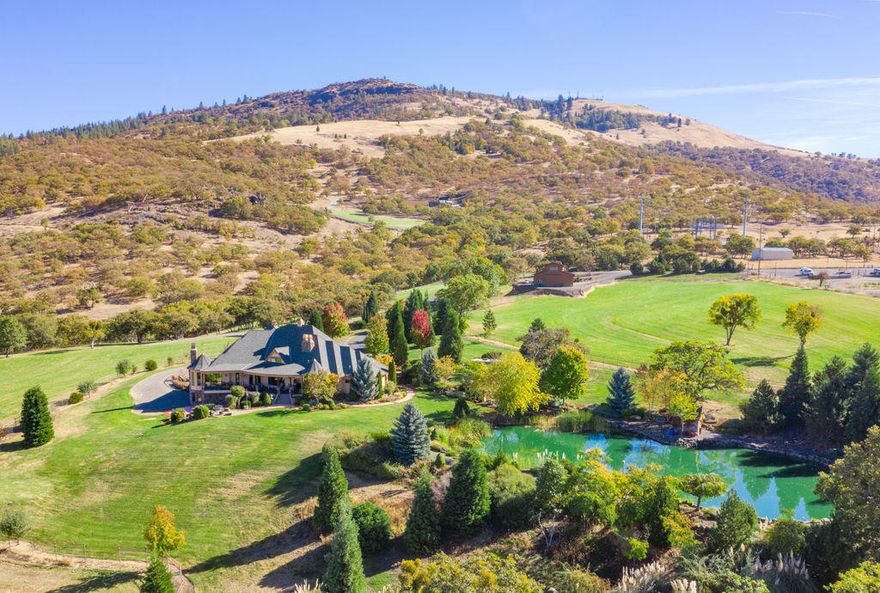 Private Masterpiece in Southern Oregon w/your own ranch on 20 acres; 10 irrigated acres, lg year around koi pond w/water falls in Crown Ranch Estates! Paved entry w/3 Electric gates. Beautiful Southern Oregon views of valley, city lights & sunsets. 1 owner home w/ 8157 SQ FT of custom quality details throughout! 3+ Car Garage w/ sports rm. 2 huge barn/shops for the cars or animal lover! 6 bdrms 4 full baths 3 half baths, 3 master suites. Gourmet kitchen, formal dining room, huge great room w/floor to ceiling stone fireplace & built-ins, beautiful granite, marble, stone & tile. Lg windows throughout to take in the beauty of the outside. Lg solid Alder doors lg trim, baseboards & crown moldings. Amazing theater media rm w/wet bar. Stone wine cellar that can hold over 300 bottles. 2 balconies overlooking the valley & beautiful landscaping! Workshop/barn w/Yoga Studio & 1.5 baths. Great downstairs Guest Quarters. A must See!!