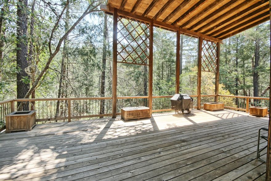Not Your Average ''Cabin in the Woods'' Modern rustic retreat on 6+ forested acres adjacent to expansive public lands. 3 thoughtful levels. Main space sits at ''treehouse'' height, elevating your experience to serene views. Cathedral-style covered deck feels like an outdoor sanctuary, relax or entertain in any season. Updated kitchen, fit for a chef, opens to dining & living areas & features a generous pantry w/ abundant shelving, freezer & second fridge. 
This level also has 1/2 bath & three access doors to wrap around deck. Upstairs are 3 cozy bedrooms, including one w/ private deck & direct access to the updated bath. Finished daylight basement offers flexible space for guests or family w/ large bonus room, bedroom, full bath & laundry room, complete w/ a laundry chute from the top floor. 2 water heaters (1 solar), full house fan system, heat control in each room & generous attic space. Circular drive, equipment shed & easy ramp entrance that allows direct car access.