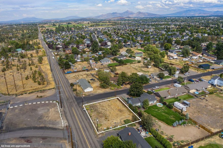 Exceptional opportunity to develop in one of Central Oregon's fastest-growing communities. This 0.27-acre flat corner lot is zoned R4, allowing for high-density residential use. The City of Redmond has previously approved plans for a single-family home, duplex, 4-plex, or any of these options with an additional Accessory Dwelling Unit (ADU). With utilities readily available at the street, and no CC&Rs or HOA restrictions, the possibilities are wide open. The lot is fully fenced and offers sweeping views of the Cascade Mountains. Ideally located near the upcoming Community Recreation Center, scheduled to open in early 2026, this property is perfect for developers, investors, or anyone looking to build a custom home with income potential. Opportunities like this are rare don't miss your chance to invest in Redmond's future.