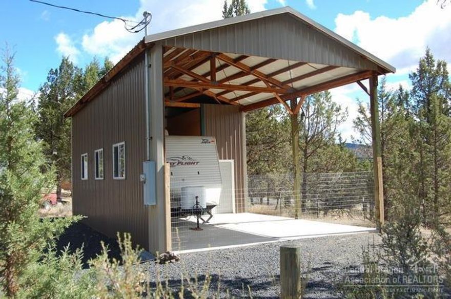 Like new, carport/storage building on over half acre with 2008 jayco bunkhouse travel trailer. The 19 foot trailer has been used 5 times and comes mostly furnished. This great property has an installed septic, community water, RV hookup and power to the building. The building is 36x20, 720sf and 14' high on cement pad with storage room in back. Building is permitted, could easily enclose to have a full garage or shop and plenty of room for a new home. Great views of the surrounding buttes.