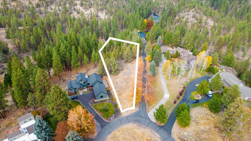 Discover an exceptional opportunity in Bend's hidden gem, the sought after Awbrey Meadows subdivision. This rare level 1.11+/- acre lot offers the perfect canvas for your dream home. Situated amidst the tranquility of mature trees you'll enjoy exclusive access to the community's scenic trails, leading you to the Deschutes River directly across from the Riley Ranch Nature Reserve.  Enjoy banner trout fishing from the back bank.  Seize the moment to claim one of the last remaining lots in this coveted neighborhood.