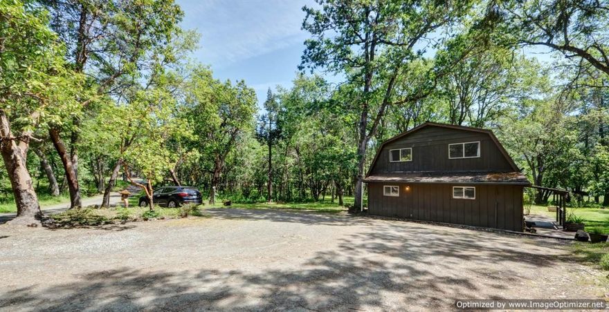 Located in a beautiful valley just a short ways from the Rogue River, this 8.85-acre parcel is nearly flat and offers lots of possible uses! The home is surrounded by shade trees and looks out over a sun-drenched pasture. This property could easily be transformed into an amazing country estate. The 2400+ square foot home has a lot of potential for adding additional bathrooms or bedrooms. The detached 2 car garage is set up for a shop. It has a full bathroom and an office area. There are several sheds, stalls and outbuildings.