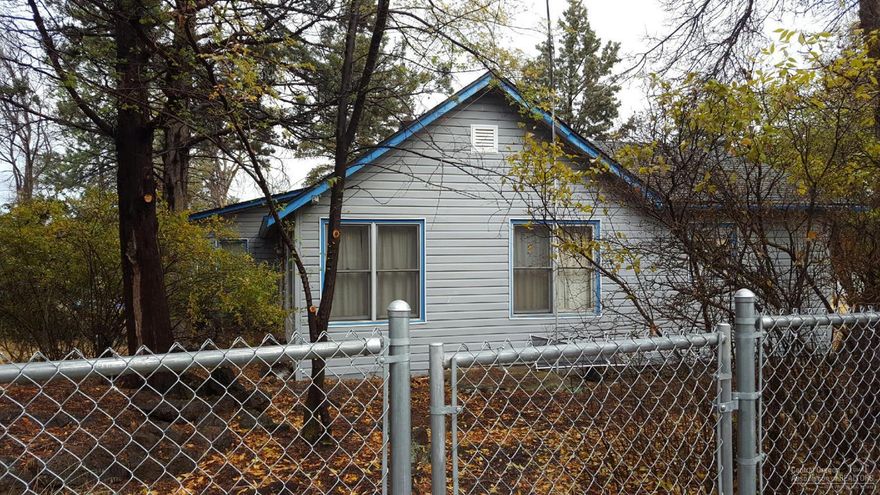 Hard to find 14.51 acre property in highly desirable area in Bend. 1478 sq. ft. home. 4 outbuildings incl. det. 30 x 22 garage/shop w/power 36 x 100 building 32 x 36 bldg, Prop. is zoned residential w/permit to operate kennel. Use is grandfathered. Fenced/cross-fenced, 10 ac. irrigation. Buyer to do their own due diligence.CLA for details.