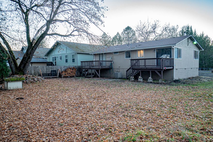 Looking for the perfect place to call home? Look no more! This cute home is awaiting it's new owners to bring their own personal touches.  Situated nicely on a large corner lot, with easy access to the beautiful Rogue River, the opportunities are endless.  Offering 3 nice sized bedrooms, large bathroom, roomy kitchen with plenty of storage and counter space plus an indoor laundry room you will not be disappointed.  There is a bonus space which has many potential uses currently be used as an attached workshop for the hobbyist at heart. Perfect for a first time home-buyer, investor or anybody looking for a rare gem with a clean slate. Tour today!