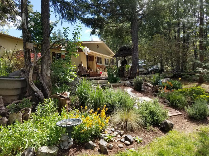 Welcome to this rare opportunity to
own this fully fenced 4.75 acres that
provides privacy, but is within distance
to town and the coast. The oversized
two-car garage provides 220 amp
service, which has a 3/4 covered
awning. Just outside the door of the
home, you're provided with a pond with
filtration & waterfall. Walking into the
home you will find a vaulted 3 bedroom
2 full bath split floor plan. Several
upgrades have been made to the home
which comes with all new appliances.
The master bedroom has an oversized
walk-in closet. The home also features
a certified wood stove and a heat
pump. A large addition is perfect for an
office or 4th bedroom. Heading to the
back of the property you will find a
great-sized backyard with a firepit that
is perfect for the whole family. Property
has a second gated access road, ATV
trails, multiple out buildings with power,
RV hookups, chicken coop, and so
much more!