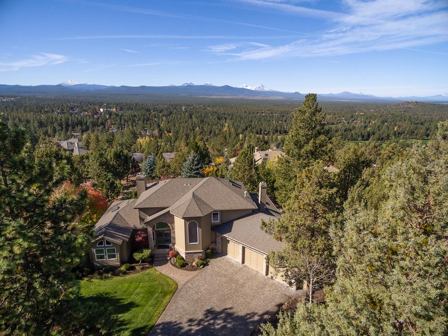Huge Cascade Mountain views steal the show at this beautifully remodeled home in Bend's West side. Set in a peaceful cul de sac on a large private lot, just minutes from schools, parks, trails, restaurants and other amenities, this home is a welcome respite from the action. A transformational remodel  includes new windows, flooring, walnet paneled fireplace and coffered ceiling, paint, new kitchen, baths and more. Vaulted ceilings and abundant windows bring in natural light and sweeping views from almost every room. The layout is ideal with a great room concept with an open kitchen, family room and casual dining, yet a grand entrance into a separate living and dining room. Expansive views of the Cascade Mountains from the upstairs primary suite will take your breath away. This home is the best of all worlds with location, views, and brand new remodel.