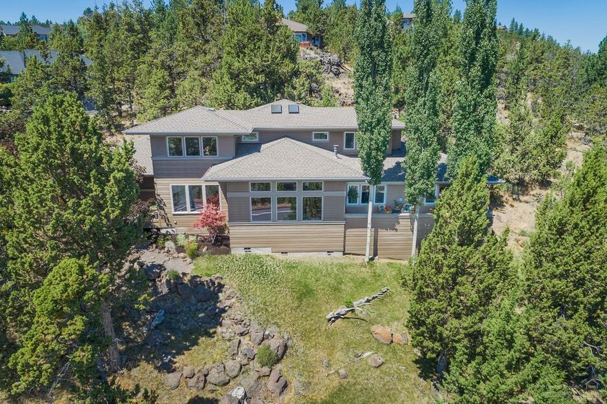 This Awbrey Butte home sits privately nestled on the hillside, and was architecturally designed to capture the panoramic easterly views. The stunning Great room has vaulted ceilings and picture windows ideal for taking in the morning sun. Well-appointed chef's kitchen has a large island & pantry. Two outdoor living areas make entertaining easy. Home office & master on the main level. Lofted second floor with 2 beds & bath. Large mudroom off the oversized 3-car garage. Absolutely gorgeous Designer's home!