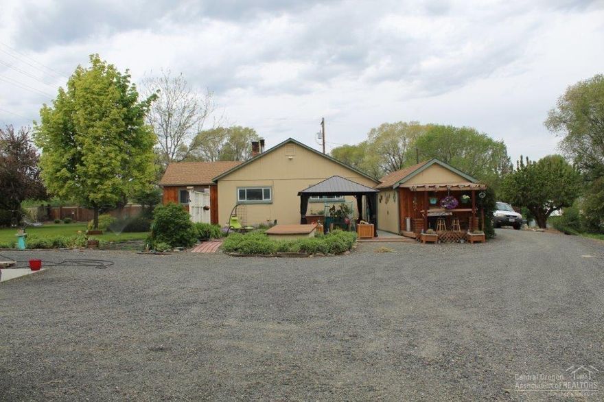 Pride Of Ownership! John Day home on .69 of an acre, see to appreciate the labor of love & fullness of this setting, country cottage built in 1956, 1374 sq ft, 3 bedroom, 1 bath, living room, bonus room w/shelving & sauna, utility room, open kitchen w/tiled counter tops & tin accents, pantry/cellar, laminate, hardwood & vinyl flooring, vinyl windows, wood & electric heat, ceiling fans, arched doorways, composition roof w/gutters, covered bbq area w/bar, privacy fence, landscaped w/irrigation ditch, board and bat & stucco siding, covered paver patio, stamped concrete patio w/large gazebo, rv parking, graveled driveway, 30 x 30 insulated shop w/man & garage doors, garden shed, wood shed, quad shed w/roll up door. $225,000 #990