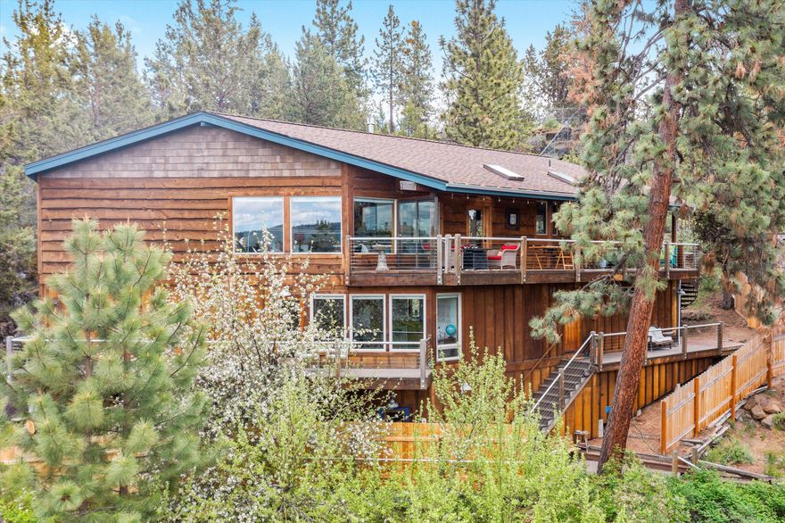Aptly named the ''FUN HOUSE'' on Airbnb, you'll quickly discover why. Imagine walking to the Deschutes River to float/paddle, strolling the river path to the Old Mill or concert at the amphitheater, cycling downtown to Farmer's Market, Drake Park & restaurants! The house is perfect for gatherings with a huge covered deck on the 3rd level that offers gorgeous mountain, river and sunset views! Whether you plan to make this your full time home or take advantage of the rare transferable STR permit for this highly successful vacation rental, you'll love the privacy of this hillside home in desirable Woodriver Village! This lovingly handcrafted home is truly one of a kind! The creative design, attention to detail and quality craftsmanship are evident in the myrtlewood floors, juniper stairway and bar area, exposed beams, hickory cabinets and fir trim framing the huge picture windows. Check out the virtual tour!